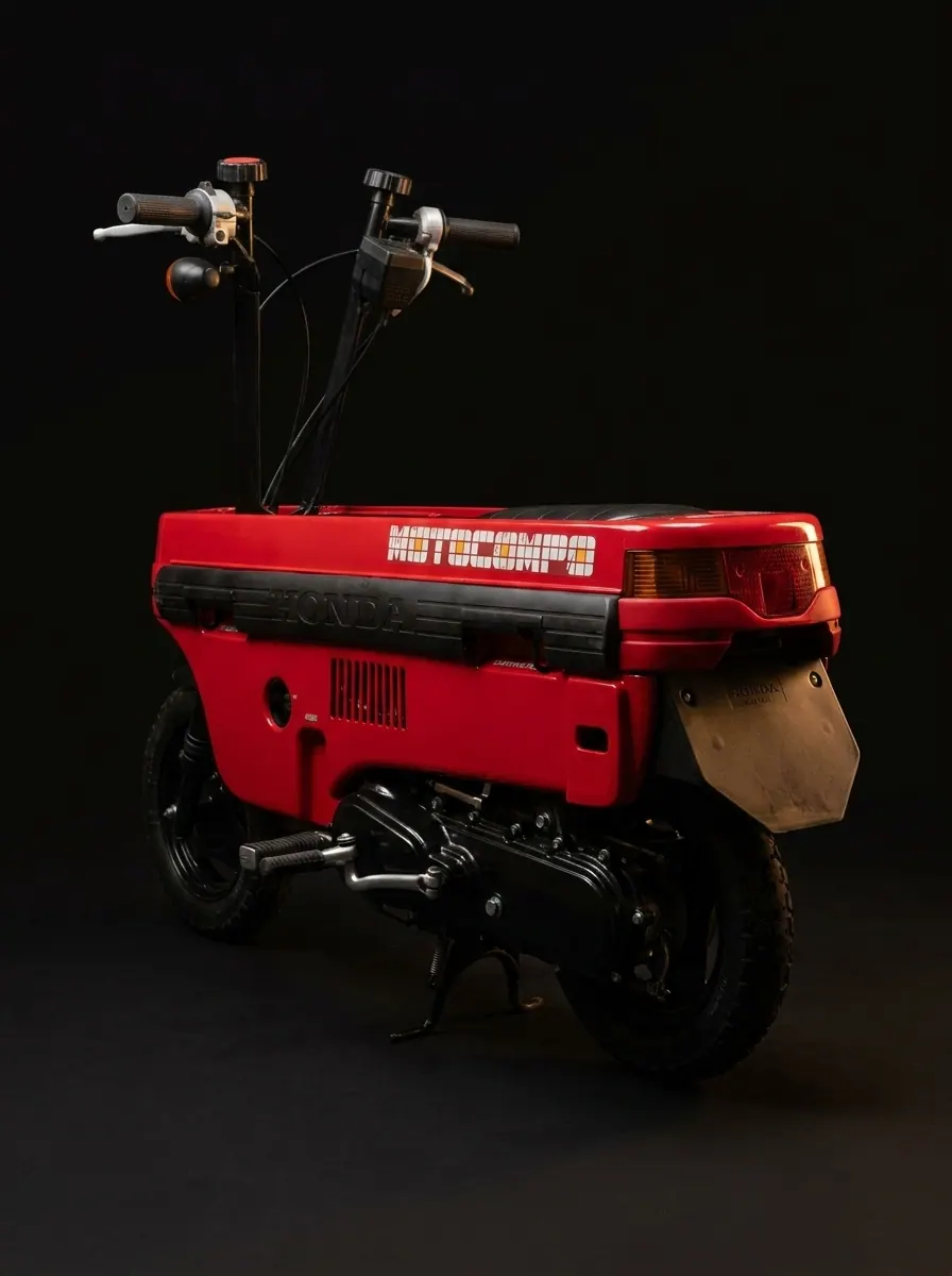 Restored Honda Motocompo shown from the rear, fitted with the recreated tail light lower cover