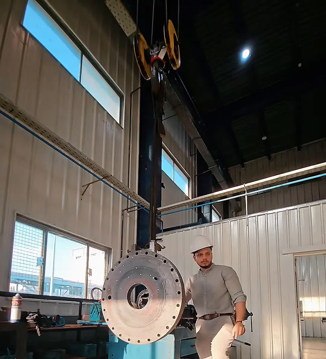 MechaCAD engineer 3D scanning an industrial boiler door on site in a working plant